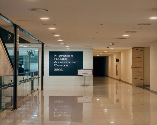 A clean administrative building interior with minimalist decor and warm lighting